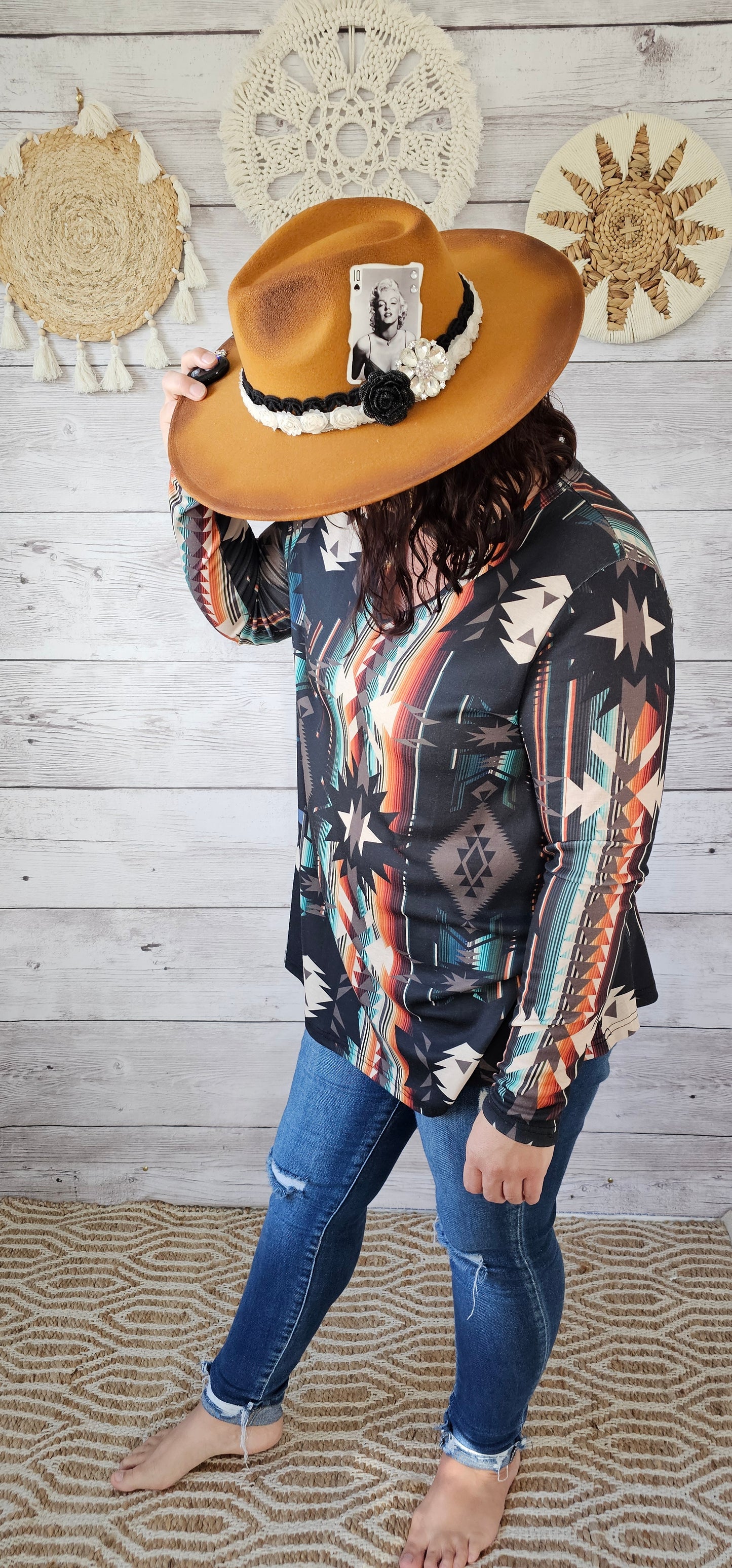 This is a comfy and casual long sleeve top. It features a rounded neckline with a V shaped cutout, long sleeves, Aztec design. Imagine yourself going to the rodeo, or line dancing. Whatever your adventure is, this is the shirt! Sizes small through x-large.