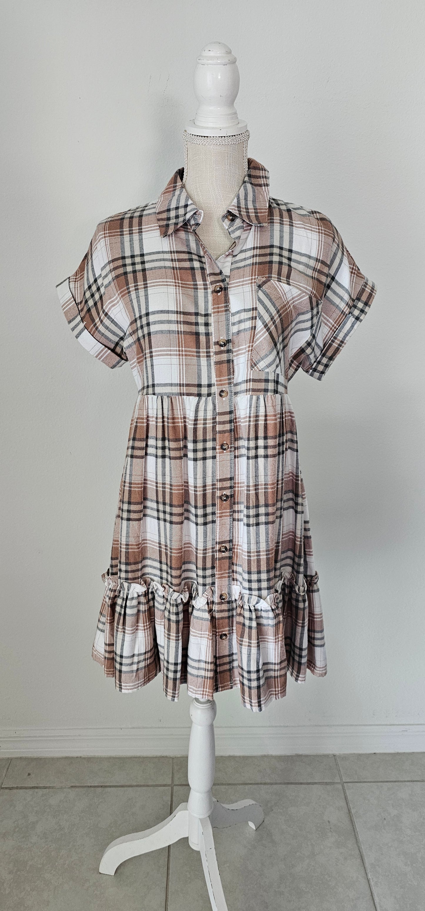Rock your modern-meets-rustic side in this plaid mini dress! Featuring a collared neckline with button down closure, cinched waist, and a ruffle hem, you'll look fly af (as fashionable) no matter the occasion. With pocket detail, this pleated plaid piece will have you looking cute and stylish all day - yesssss girl! Sizes small through large.