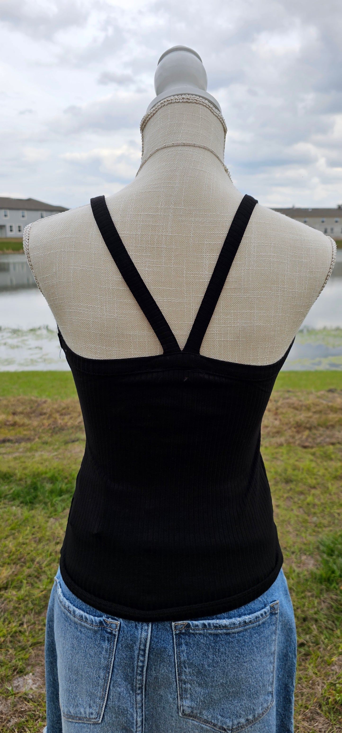 This “Basic Babe Tank Top: Black” features a ribbed fabric, sleeveless tank top with v-neck and back. This is a great basic staple piece! Sizes small through x-large.