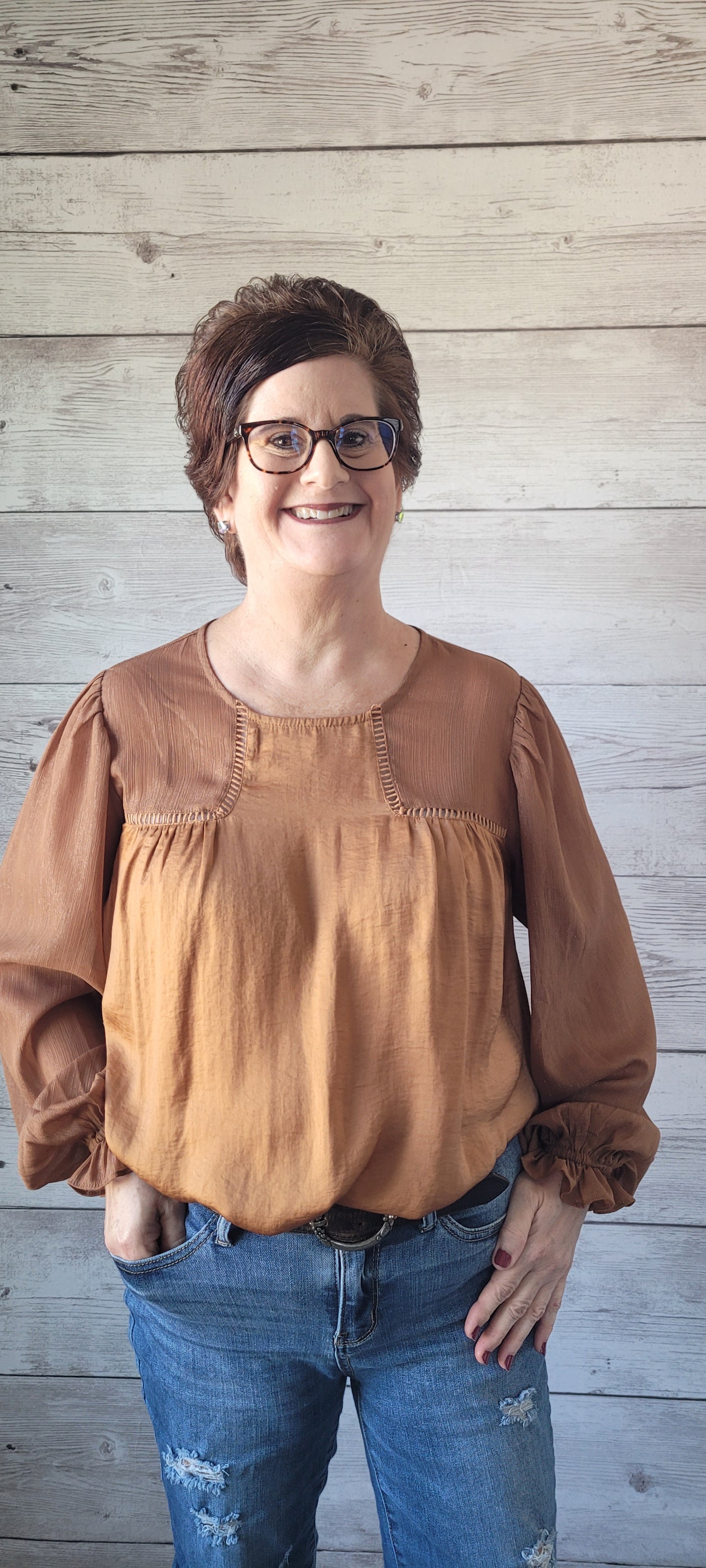 Feel like royalty in our Sophia Camel Satin Blouse! With a round neck and keyhole back button closure, this top offers the perfect balance between style and comfort. Puff sleeves with gathered ruffles and ladder trim detail add a unique touch, as does the front and back shirring. Shine bright with your own golden thread of Lurex contrast! Sizes small through large.