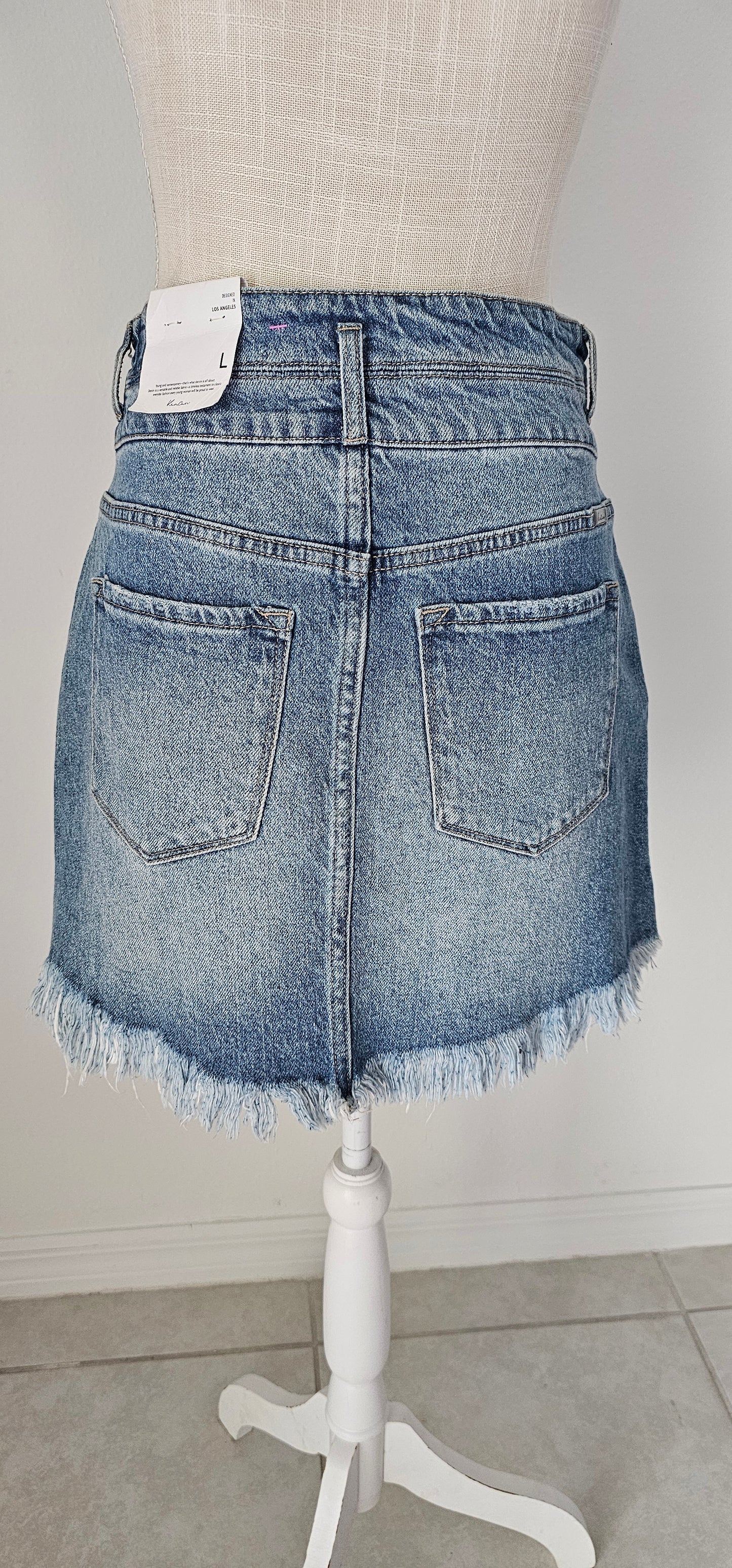 Imagine yourself in this cute denim high rise skirt. This skirt features a frayed hem. A jean skirt is a staple to anyone's life. This cute skirt you can dress up or down. Imagine yourself wearing this to the office, school, out on the town, or just because. This cute skirt can be worn with pretty much any top, sweater, or sweatshirt. Sizes small through x-large.