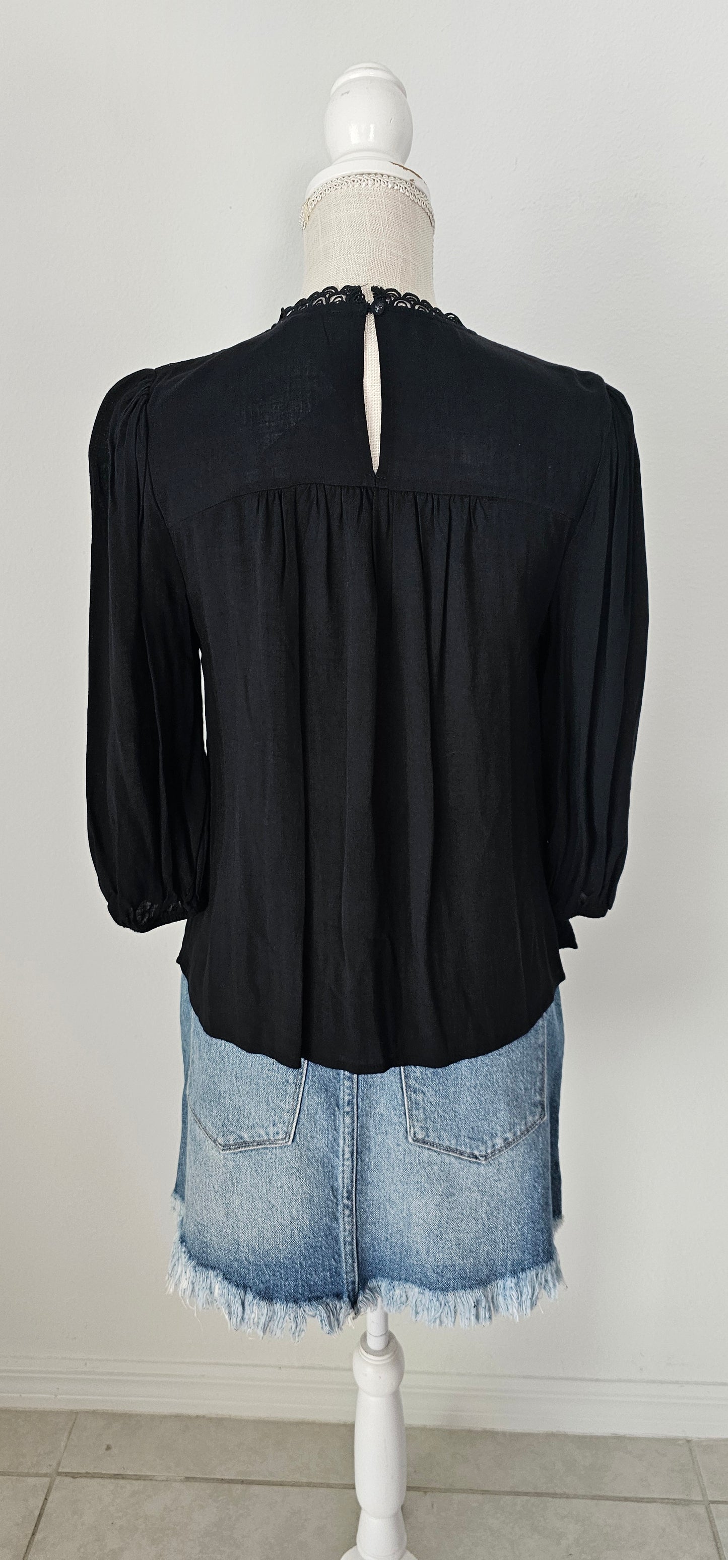 Rock your look with this ravishing top that'll take your fashion to the next level! With its elegant lace mock neck, stylish back-button closure with keyhole, and oh-so-pretty front lace inset and pleated bubble sleeves, you'll be sure to draw admiring glances wherever you go. Let's get fabulous! Sizes small through large.