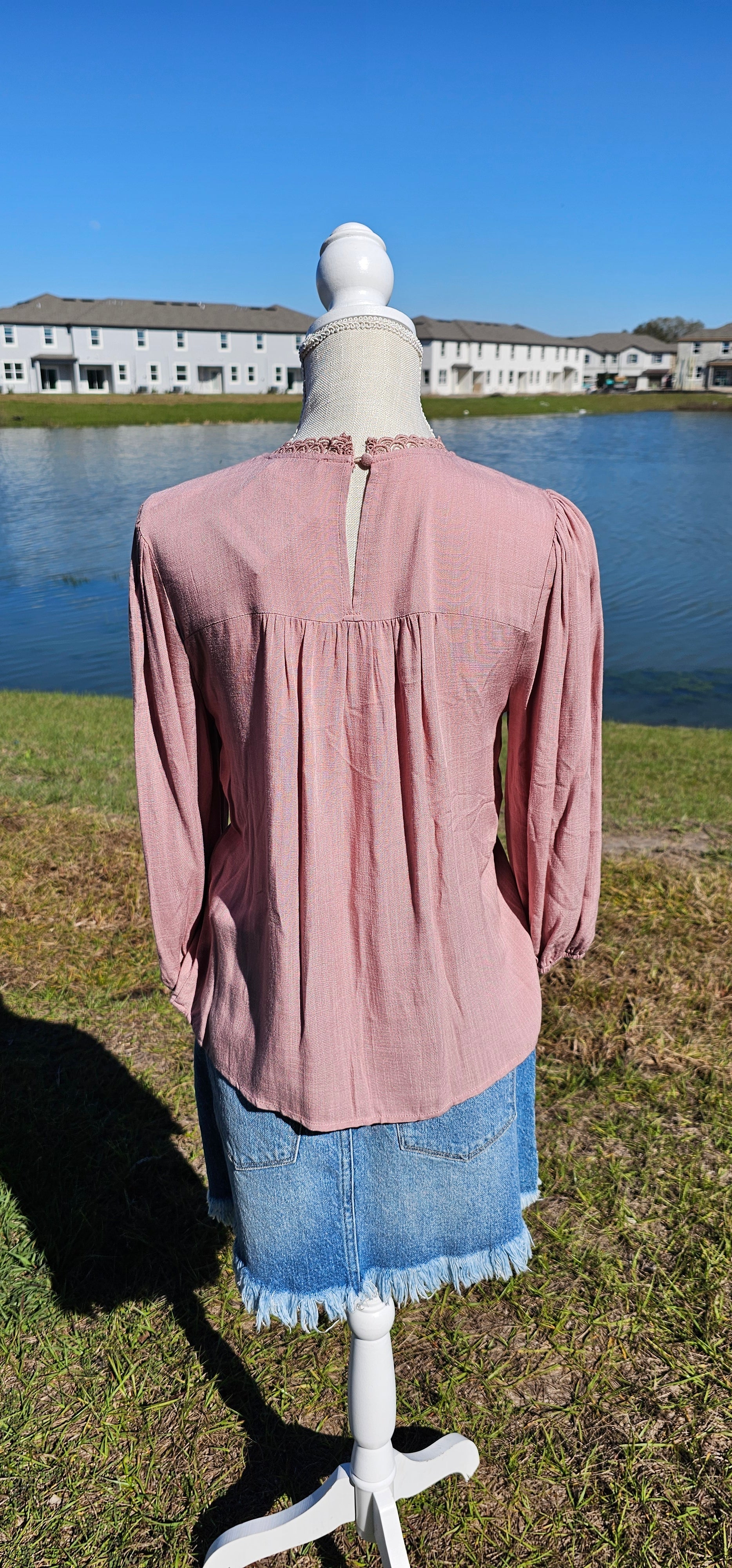 Rock your look with this ravishing top that'll take your fashion to the next level! With its elegant lace mock neck, stylish back-button closure with keyhole, and oh-so-pretty front lace inset and pleated bubble sleeves, you'll be sure to draw admiring glances wherever you go. Let's get fabulous! Sizes small through large.