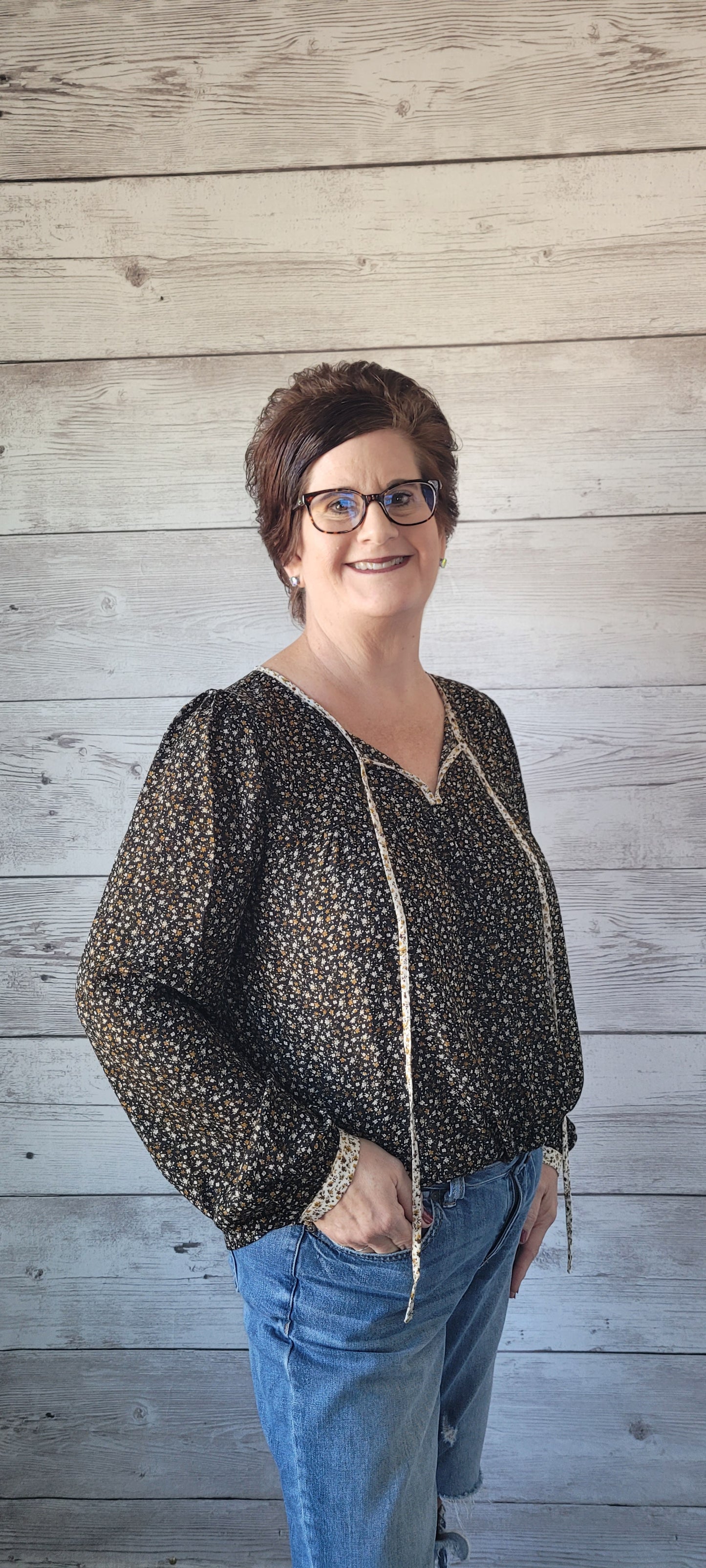Elevate your outfit with the Luna Black & Ivory Floral Blouse! This blouse features a front tie and split round neck for an undeniably fun and flirty look, plus cute button cuff sleeves for an extra stylish touch. Jazz up any occasion with this unique and playful garment and bring the party wherever you go! Small through large.