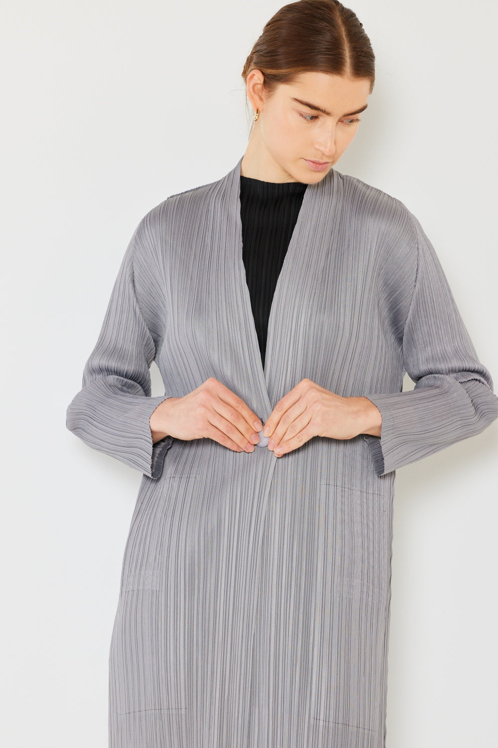 The Pleated Long Sleeve Cardigan is a versatile and chic layering piece for your wardrobe. With its pleated detailing and long sleeves, this cardigan offers a stylish and sophisticated look. The pleats add texture and visual interest to the classic cardigan design.