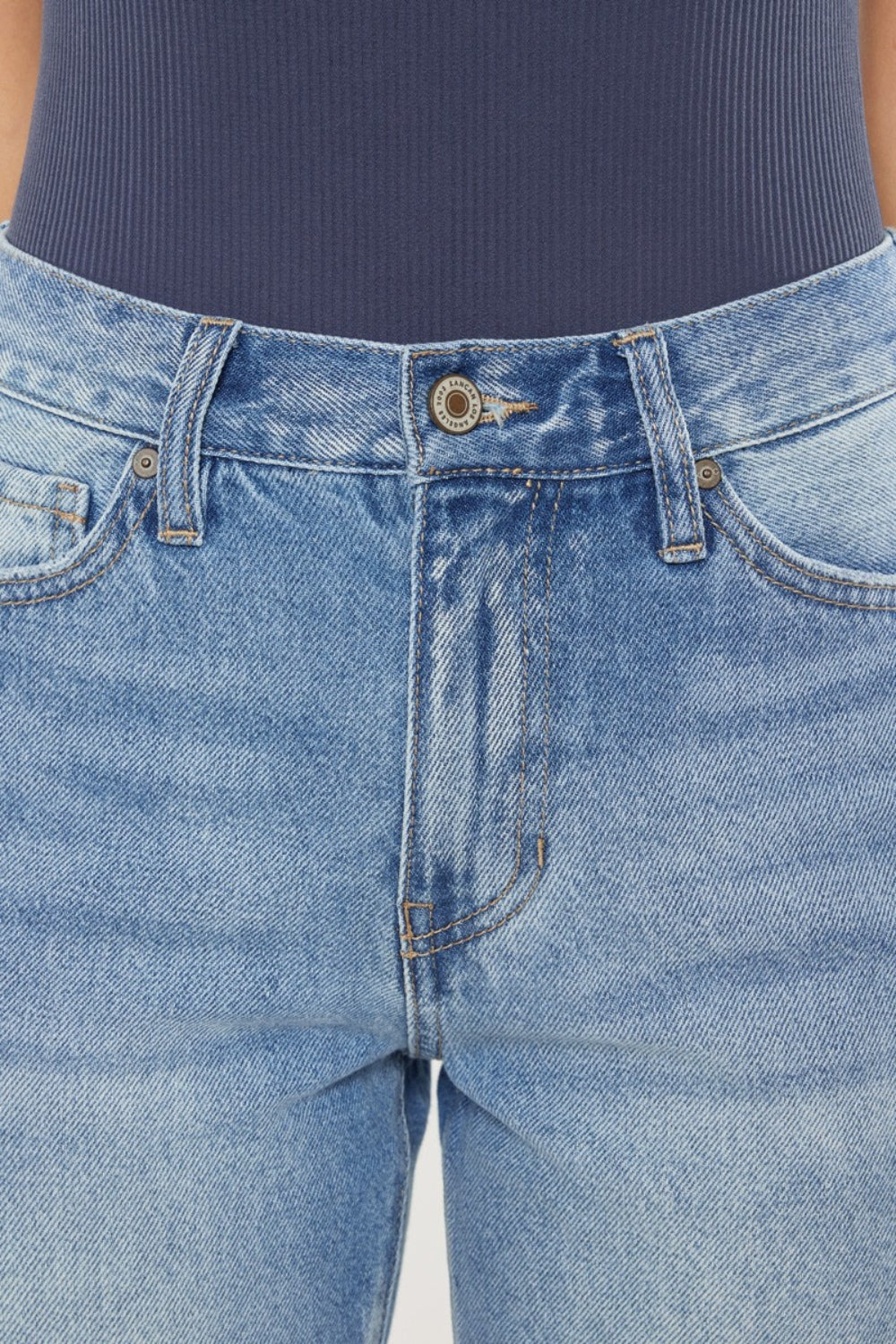 High Waist Chewed Up Straight Mom Jeans are the ultimate combination of vintage-inspired style and trendy edge. These jeans, with their high waistline, provide a flattering and comfortable fit that accentuates your curves.