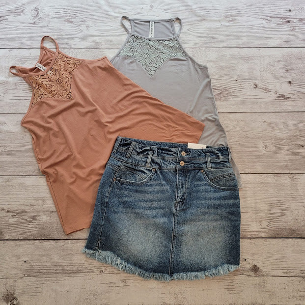 Imagine yourself in this cute denim high rise skirt. This skirt features a frayed hem. A jean skirt is a staple to anyone's life. This cute skirt you can dress up or down. Imagine yourself wearing this to the office, school, out on the town, or just because. This cute skirt can be worn with pretty much any top, sweater, or sweatshirt.