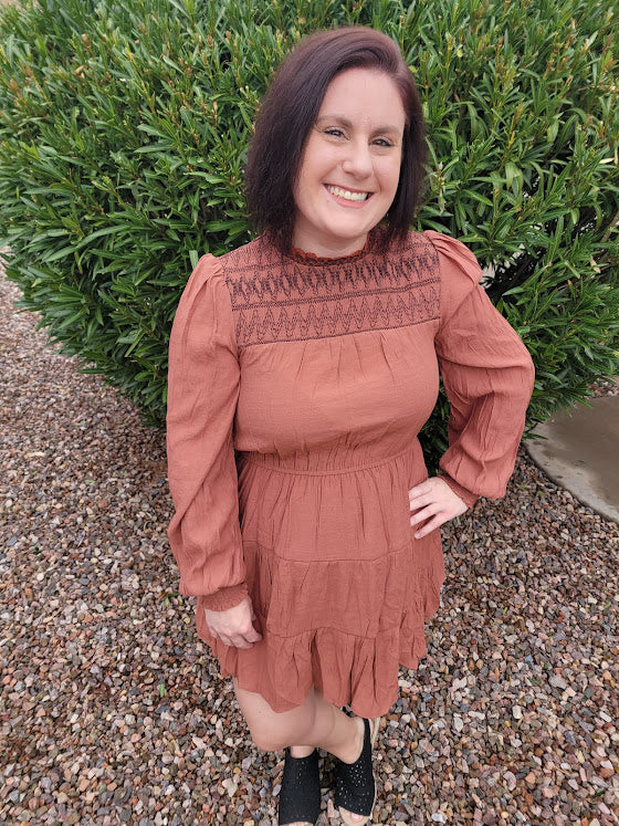 Imagine yourself going to the rodeo, hanging out with friends, or just because you want to. This cute little number has a smocked neckline and cuffs, balloon sleeves, tiered layers, cinched waist, and button on back neckline. This is a cute and unique dress. You will not walk down the street and see everyone else wearing this cute dress. You be you!