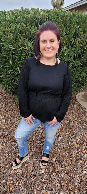 This black long sleeved cinched waist, with a scoop neckline is a must have staple to your wardrobe. This is a unique black top, so you will be the only one on the block with this cute top. Dress it up, or use it as a casual piece.
