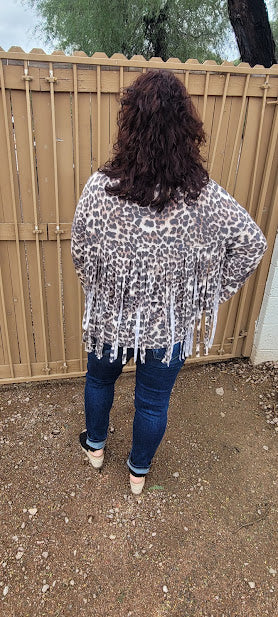 Leopard print top with v-neckline, long sleeves and fringe back. This cute shirt adds a little sass to your life. "Fringe With Benefits" is very unique, so you will not find another one like it! Go ahead and put your boots on! Go dancing, or to the rodeo, wear this cutie for any reason, or no reason at all. Strut your stuff! Sizes small through large.