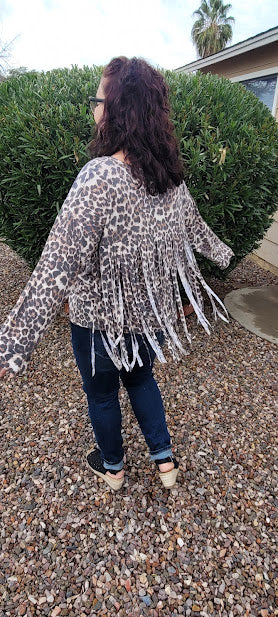 Leopard print top with v-neckline, long sleeves and fringe back. This cute shirt adds a little sass to your life. "Fringe With Benefits" is very unique, so you will not find another one like it! Go ahead and put your boots on! Go dancing, or to the rodeo, wear this cutie for any reason, or no reason at all. Strut your stuff! Sizes small through large.