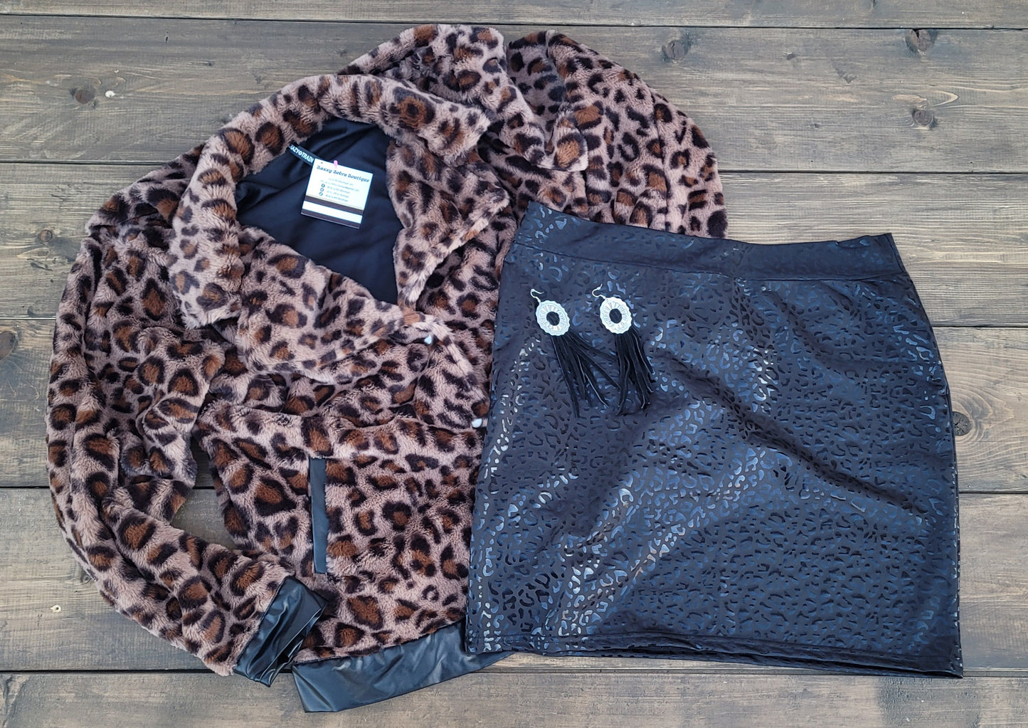 Imagine yourself in this cute little black skirt. This is a fitted mini skirt that is super edgy and chic. You'll be sure to turn heads in this skirt. It features a glossy animal print that is black, and a stretchy waist band. Go ahead and strut your stuff girl!