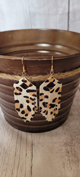 White Leopard Fringe Earrings Elongated hexagon design Diamond cutout Genuine leather Leopard print Gold fish hook Rubber earring back Whether you want to be on the wild side or classy this earring set it will add a fun touch to your outfit