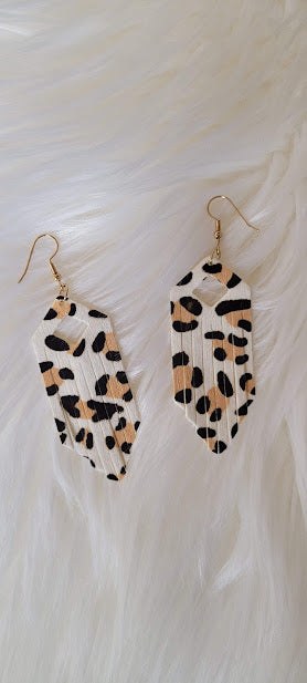 White Leopard Fringe Earrings Elongated hexagon design Diamond cutout Genuine leather Leopard print Gold fish hook Rubber earring back Whether you want to be on the wild side or classy this earring set it will add a fun touch to your outfit