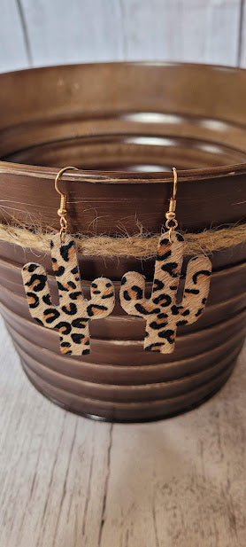 Light Brown Leopard Cactus Earrings Light brown genuine leather Leopard print Gold fish hook Country or western look Whether you want to be on the wild side or classy this earring set it will add a fun touch to your outfit