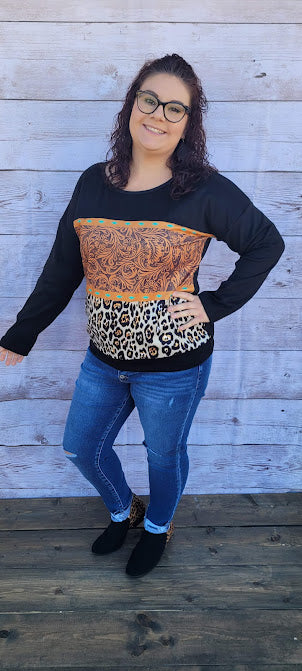Canyon Cowgirl Description This is a comfy, buttery soft, heavier weight top, but not a sweatshirt. Canyon Cowgirl is a long sleeve black top, featuring blocked leopard print and western print on the front. Pair with your favorite pair of denim jeans, shorts, or jean skirt. Don’t be afraid to get creative! Sizes medium through x-large