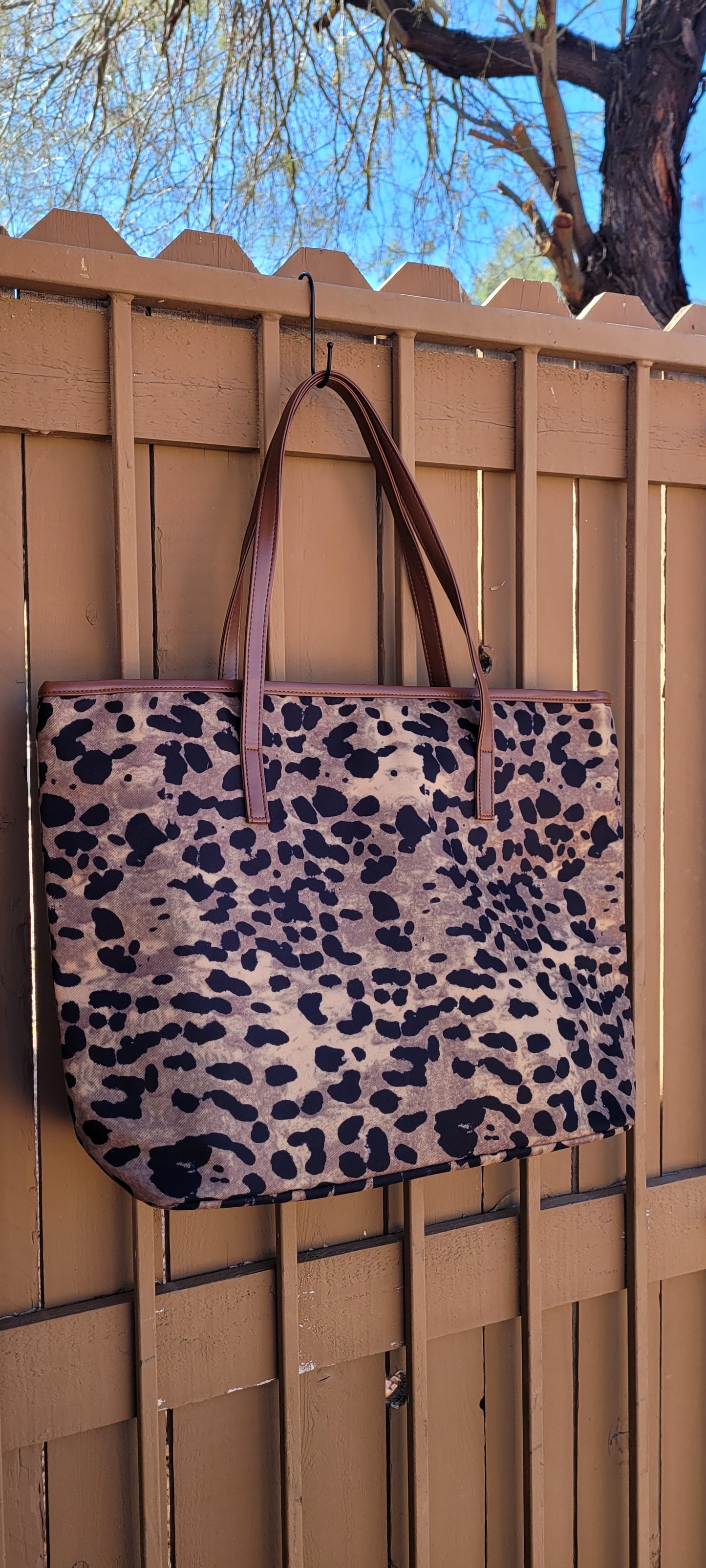 This sturdy bag comes with an interior zip pocket and cell phone pocket to keep things neat and organized. It's perfect for carrying your essentials when you step out for a day at the beach, office or for a weekend getaway. This tote bag features a zip closure to keep your necessities secure while the double shoulder handles make for easy carrying. The material is 100% polyester. Measures: 17 ½'' W x 12'' H x 5'' D