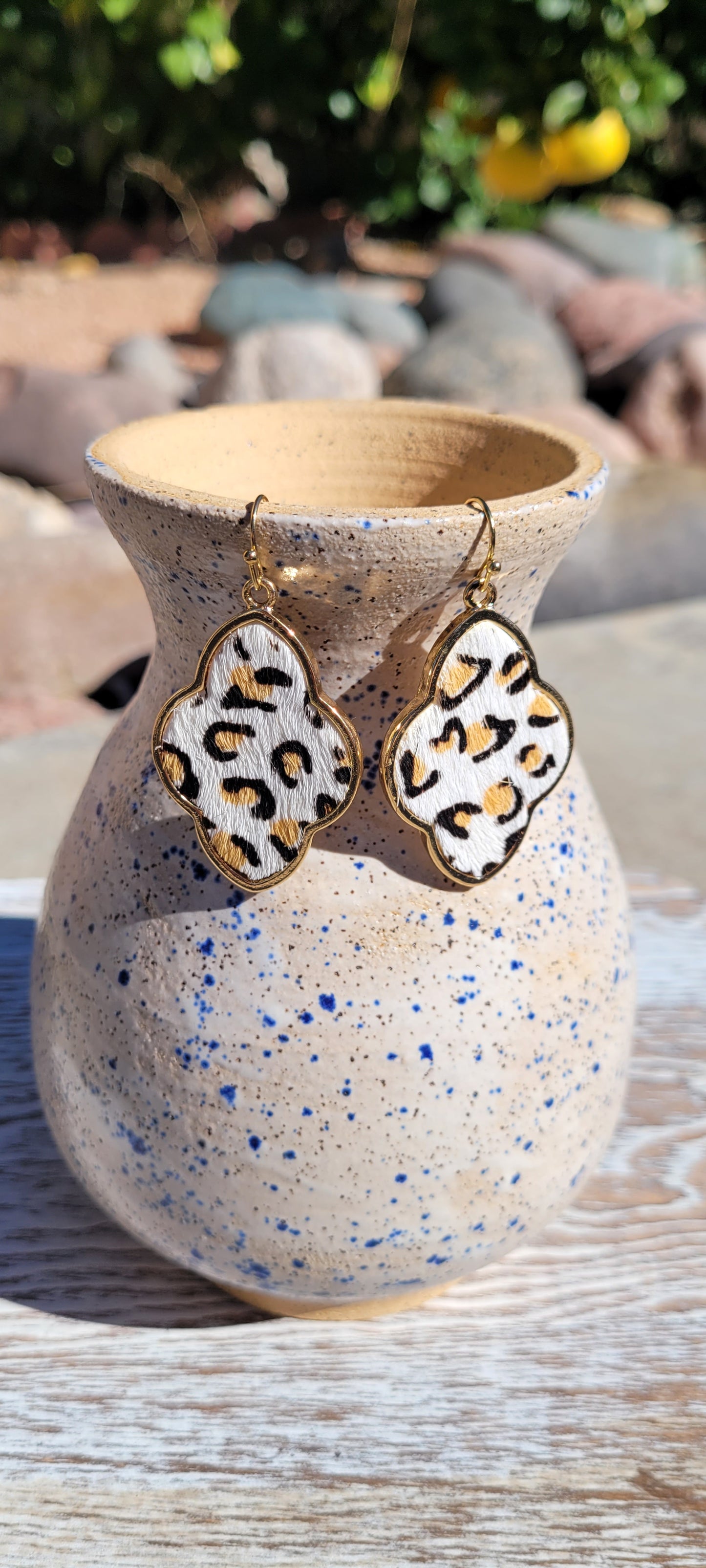 White furry genuine leather Leopard print Quatrefoil shape Brushed gold fish hook dangle earrings Rubber earring back Whether you want to be on the wild side or classy this earring set it will add a fun touch to your outfit