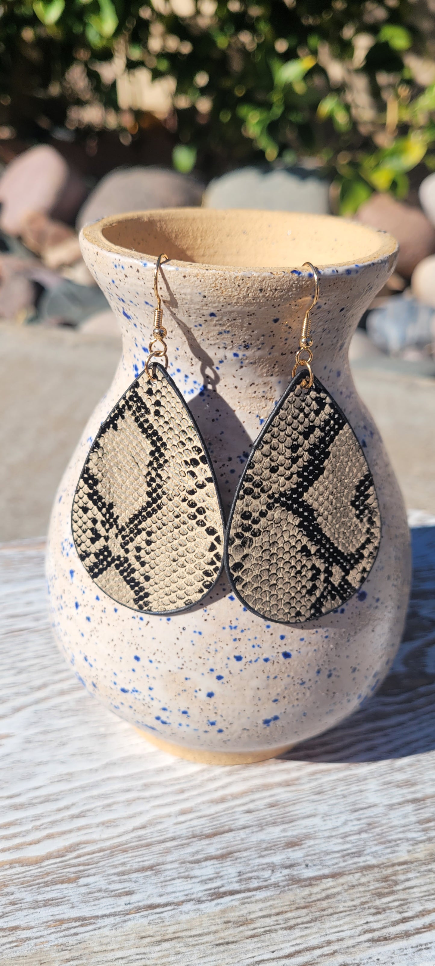 Teardrop shape Gray, cream, and black faux leather Brushed gold fish hook dangle earrings Rubber earring back Drop length 3” Whether you want to be on the wild side or classy this earring set it will add a fun touch to your outfit