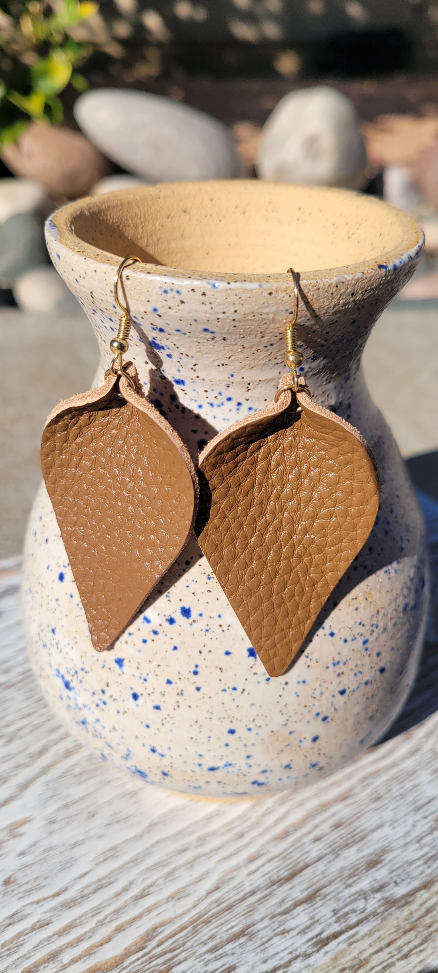 Dewdrop shape Brown genuine leather Shiny brown Brushed gold fish hook dangle earrings Rubber earring back Drop length 3”, width 1.5” Whether you want to be on the wild side or classy this earring set it will add a fun touch to your outfit