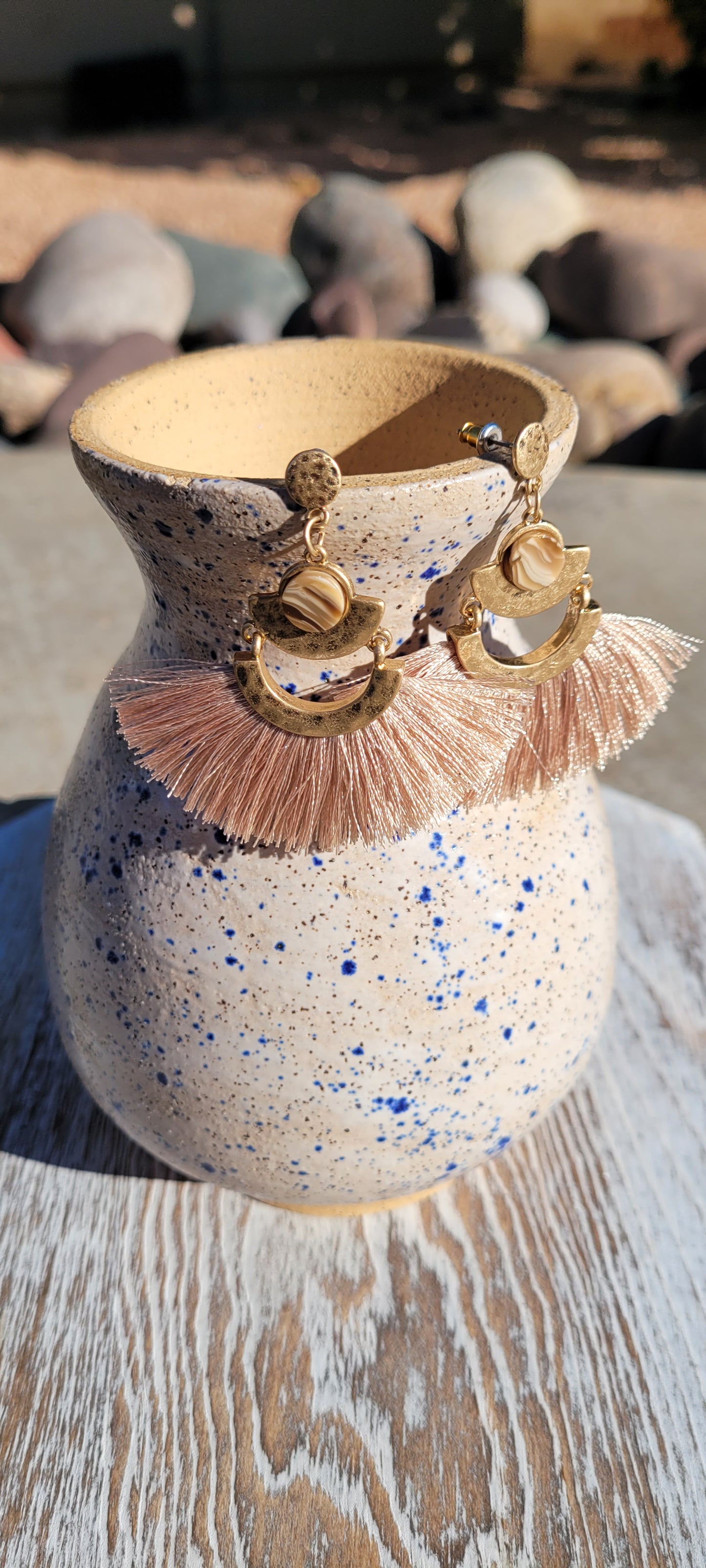 Tan tassels Brushed gold dangle design Marbled jewel Brushed gold stud earrings Metal earring back Length 2”, width 2” Whether you want to be on the wild side or classy this earring set it will add a fun touch to your outfit