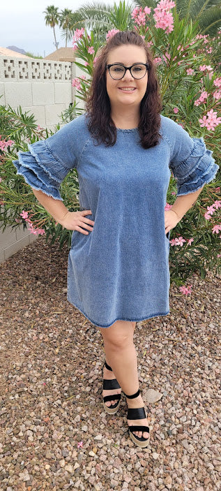 This light color denim dress features layered, short sleeves which have ruffles that are fringed/frayed, and comes above the knee . Just slip it on over your head and you are ready to go! Go ahead and strut your stuff! This dress is great for a date, going to the office, or hanging out with the girls. Change the look of your dress by wearing different style belts as an added feature. Belt not included. Sizes small through large.