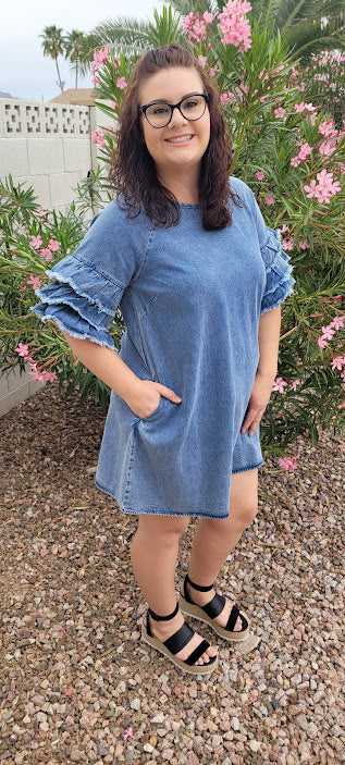 This light color denim dress features layered, short sleeves which have ruffles that are fringed/frayed, and comes above the knee . Just slip it on over your head and you are ready to go! Go ahead and strut your stuff! This dress is great for a date, going to the office, or hanging out with the girls. Change the look of your dress by wearing different style belts as an added feature. Belt not included. Sizes small through large.