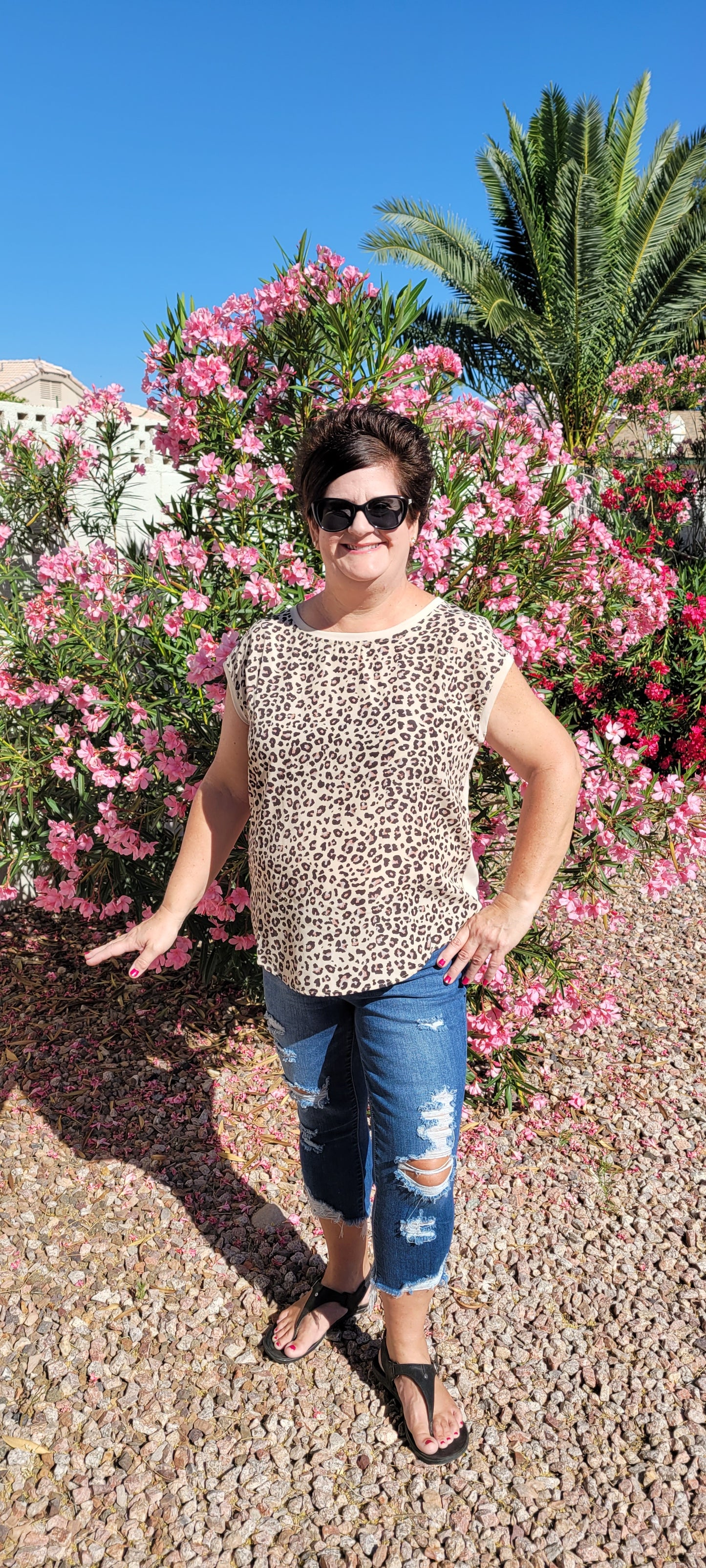 “Road Less Traveled” is a sleeveless top, with leopard print front (beige, brown, camel, agreeable gray) and contrast back, boat neckline, trimmed with beige soft modal, and rounded hemline. This is a satiny, silky soft high-low top. This is definitely a business or casual top. Sizes small through large.