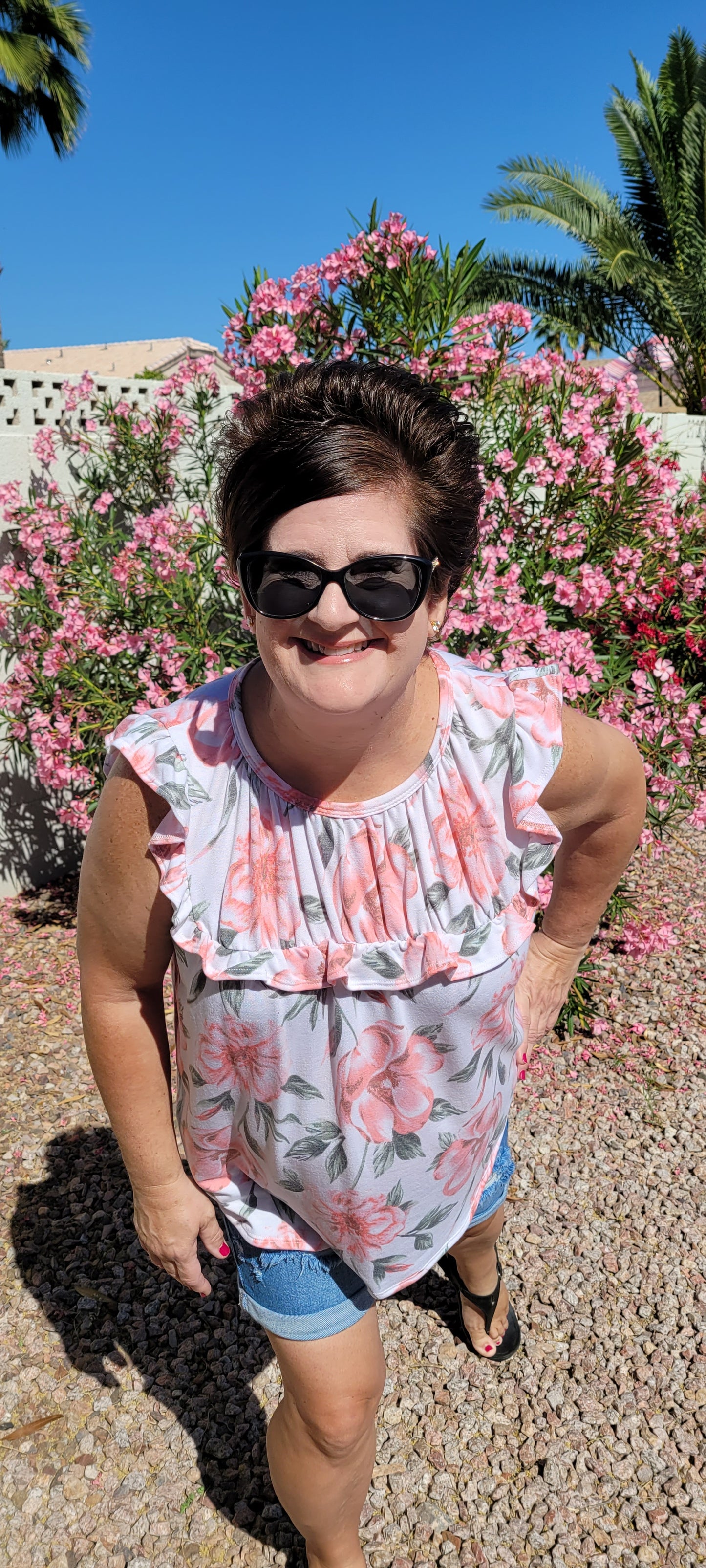 “Garden Goddess” is a comfy and casual top! This sleeveless white shirt features a beautiful pink and sage floral print. It is a baby doll top with rounded neckline, ruffled details on sleeves and chest. This top is so soft and comfy! There is a terry cloth texture inside. Sizes small through large.
