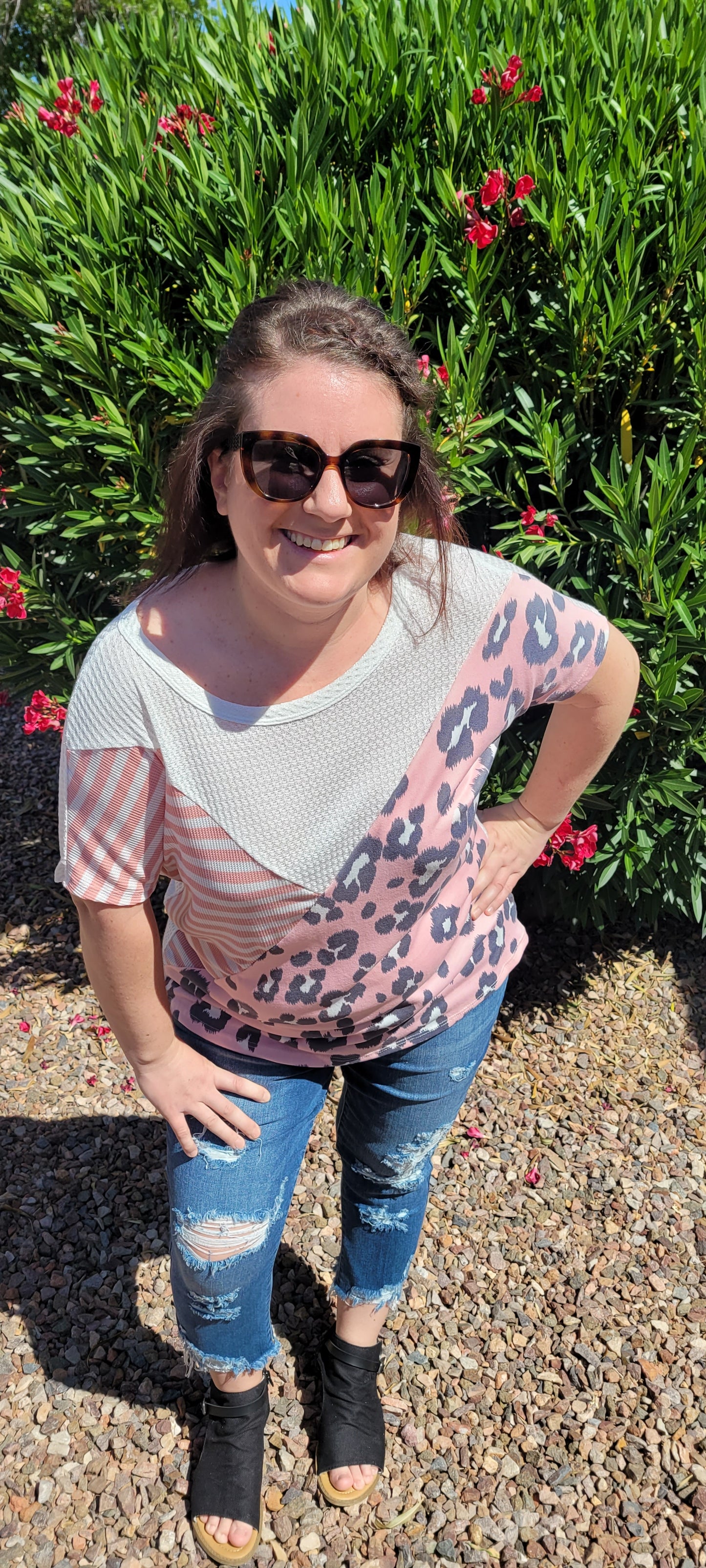 “Spoken From The Heart” is a comfy and casual t-shirt! This short sleeve shirt features pattern blocking, leopard print (pink, gray, white), stripes (coral, white) and solid waffle (white). This shirt has three different materials and textures, and a rounded neckline. Pair with your favorite pair of denim jeans, shorts, or skirt. Sizes small through large.