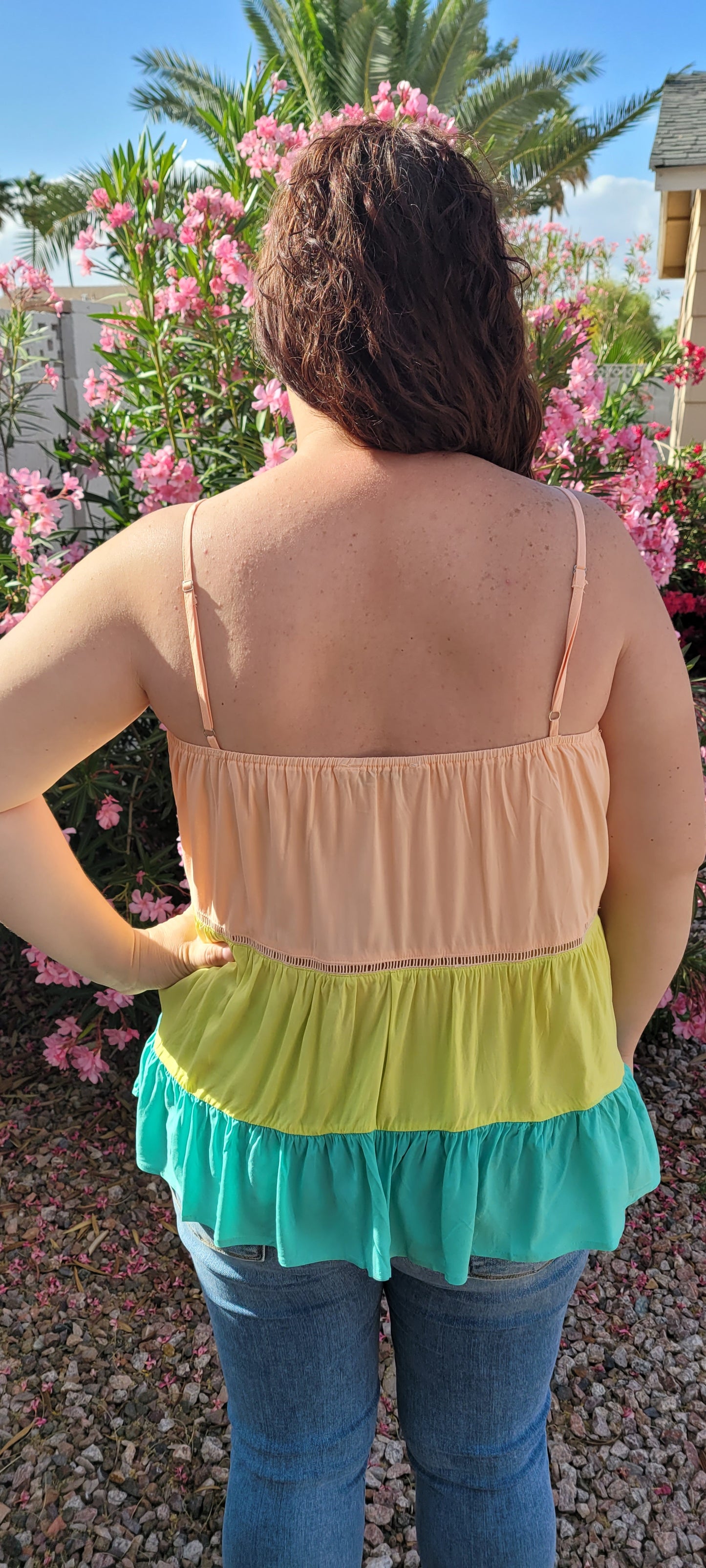 “Tutti Frutti” is a vibrant color block tank top. This tank top features three tiers of color (sherbet orange, lime green, light teal), adjustable straps, elastic back, pleated flare top and cute peekaboo lace trim. This top does not have stretch, but is loose fitting and longer in length. It is super lightweight and breathable. Sizes small through large.
