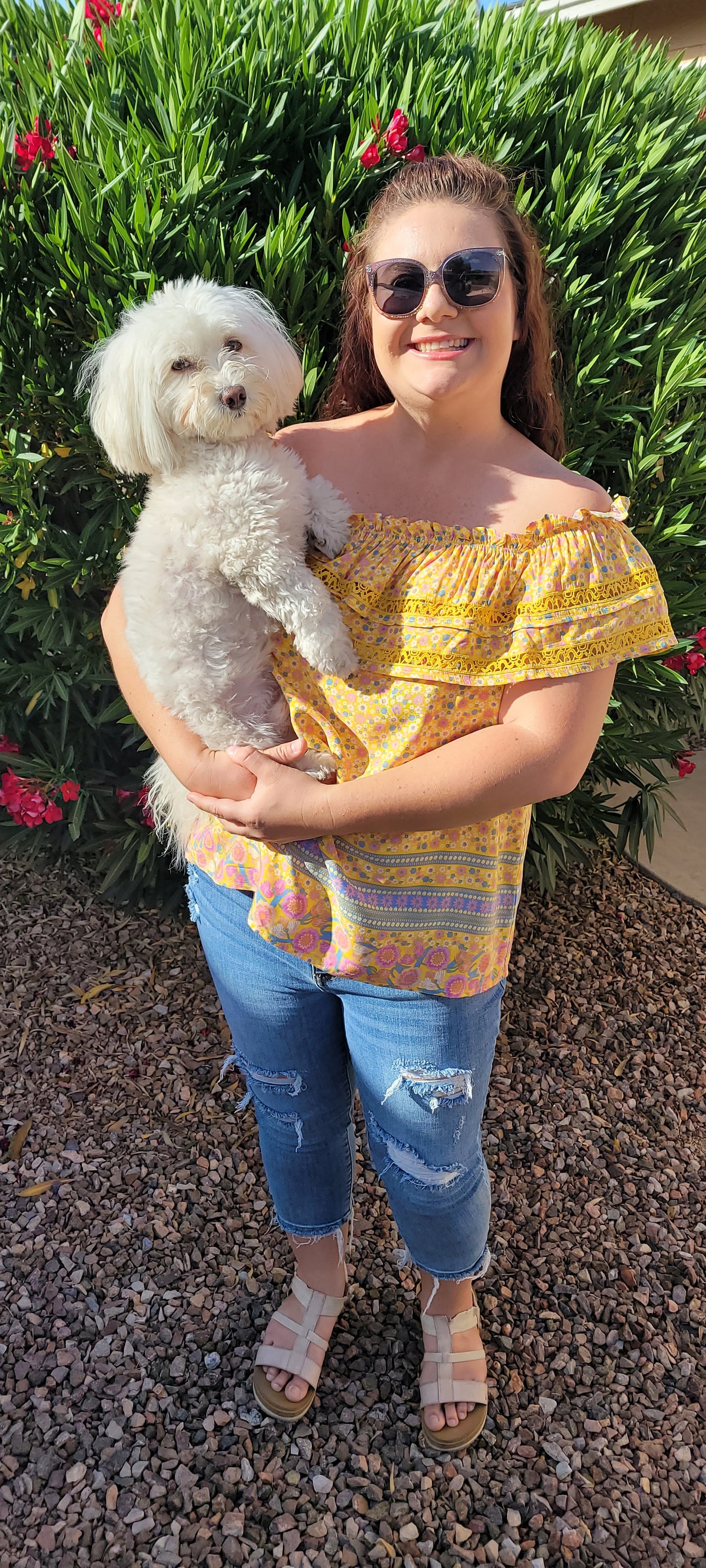 “Sunshine On My Shoulders” is an off the shoulder smock top. This top features a ray of subdued colors (dandelion yellow, mauve, ceil blue, white), elastic ruffled neckline, and crochet lace design. This top is a longer length, it does not have stretch, and is super lightweight and breathable. Sizes small through large.