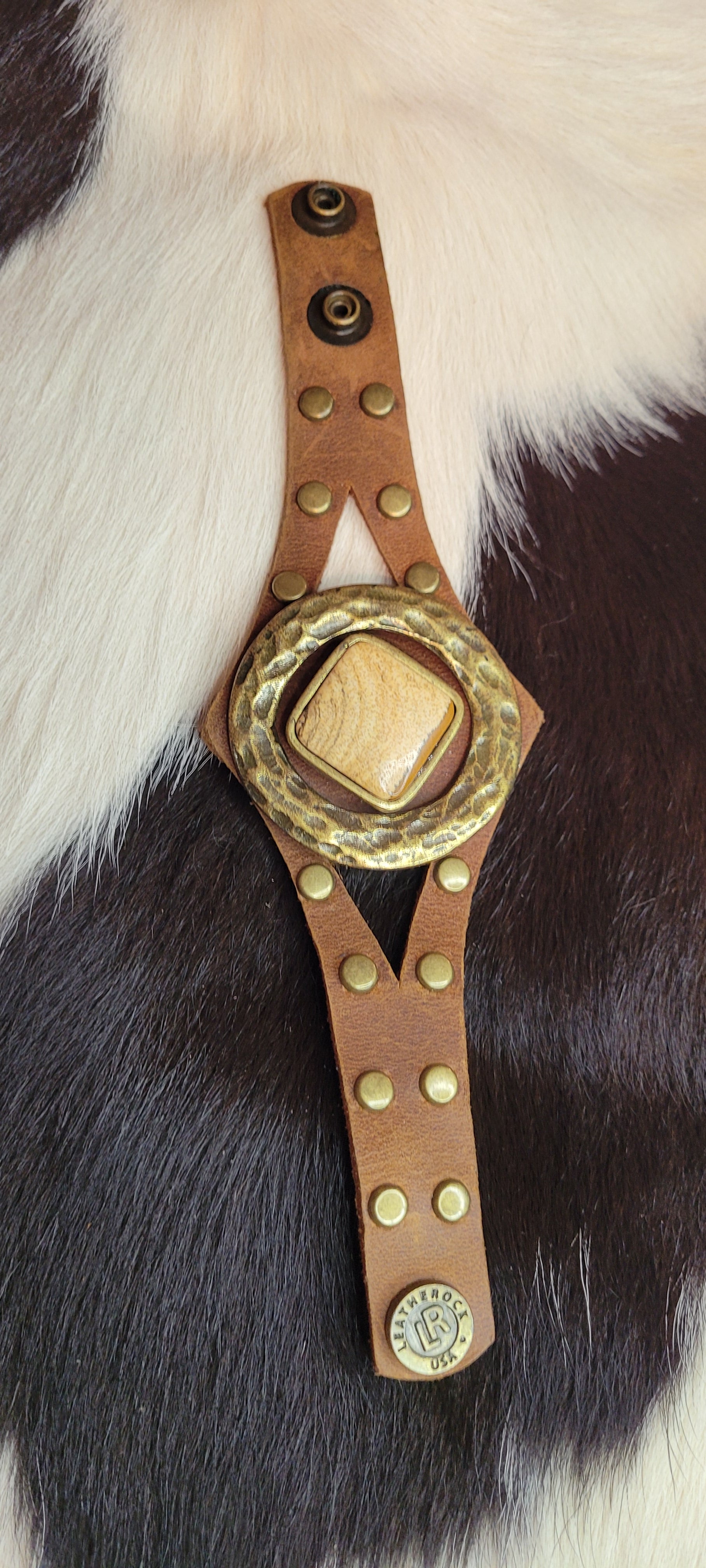 Semi-precious stone Accented with hardware and studs Genuine Leather Adjustable snap closure Color: chocolate brown Length: 8.5 inch Limited supply / one of a kind! Made in the USA