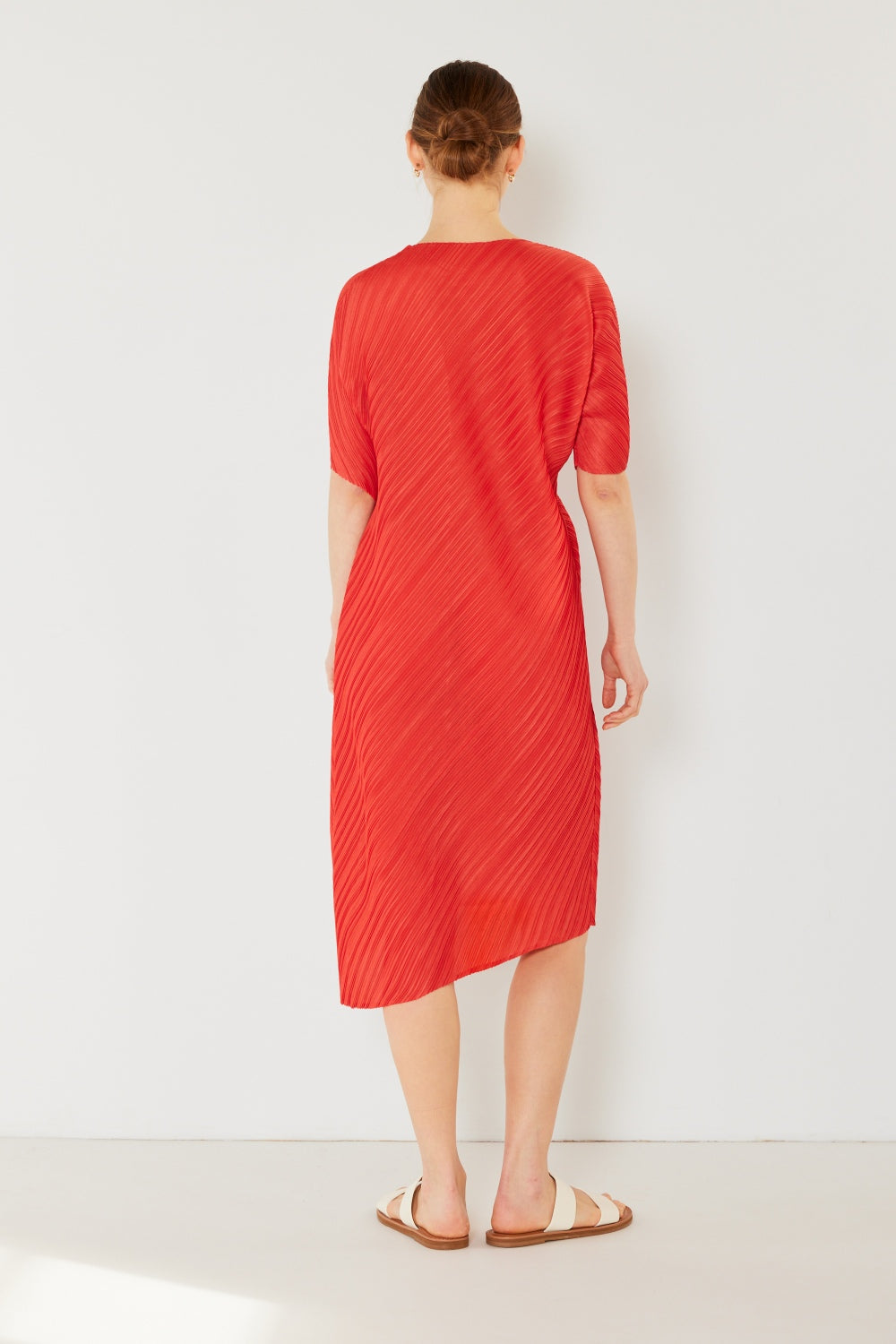 The Pleated Dolman Sleeve Dress is a modern and chic addition to your wardrobe. With its unique dolman sleeves and pleated detailing, this dress offers a stylish and sophisticated look. The relaxed silhouette and pleats create a flattering and comfortable fit.