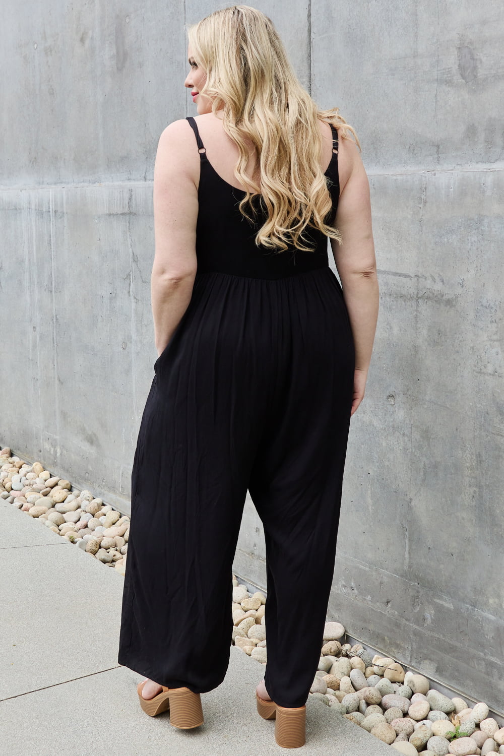This jumpsuit is designed to be your go-to outfit for any occasion, whether you're running errands, attending a casual gathering, or simply lounging at home. This jumpsuit features a wide leg silhouette that not only offers a chic and contemporary look but also allows for unrestricted movement.