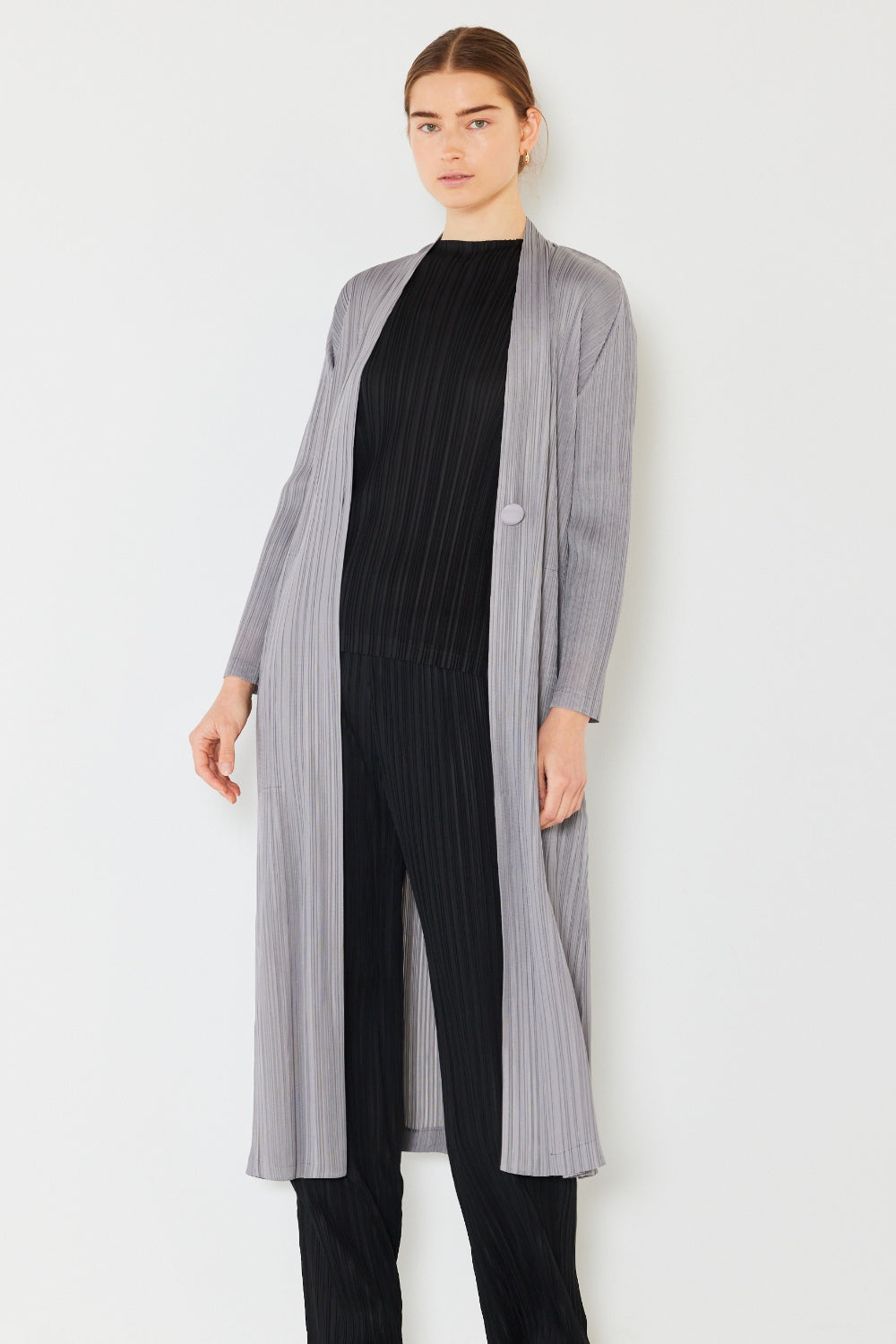 The Pleated Long Sleeve Cardigan is a versatile and chic layering piece for your wardrobe. With its pleated detailing and long sleeves, this cardigan offers a stylish and sophisticated look. The pleats add texture and visual interest to the classic cardigan design.