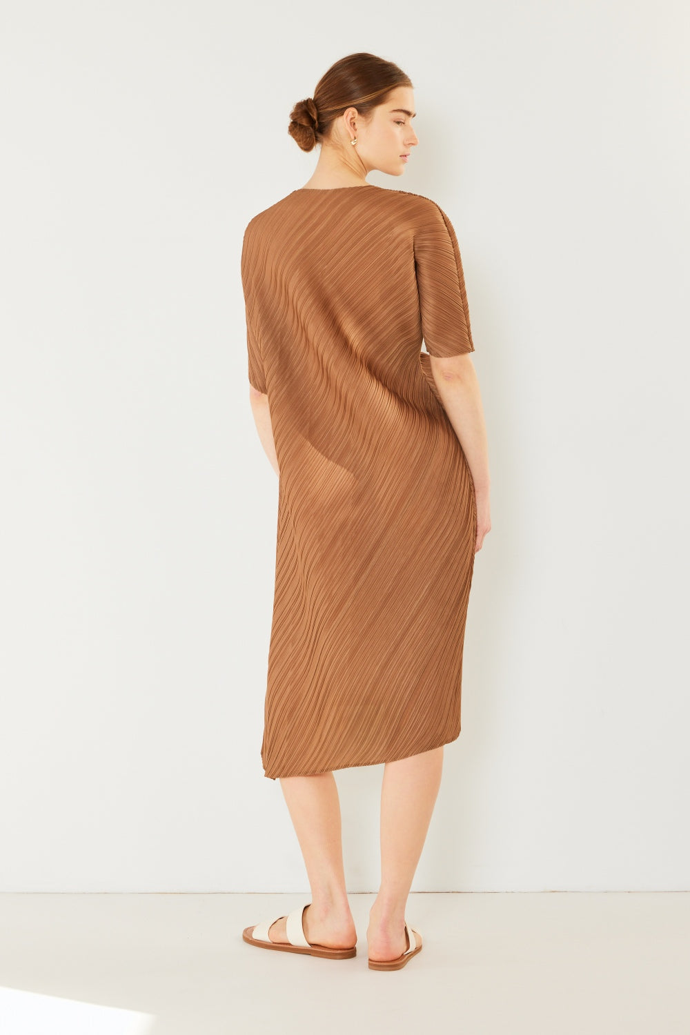 The Pleated Dolman Sleeve Dress is a modern and chic addition to your wardrobe. With its unique dolman sleeves and pleated detailing, this dress offers a stylish and sophisticated look. The relaxed silhouette and pleats create a flattering and comfortable fit.