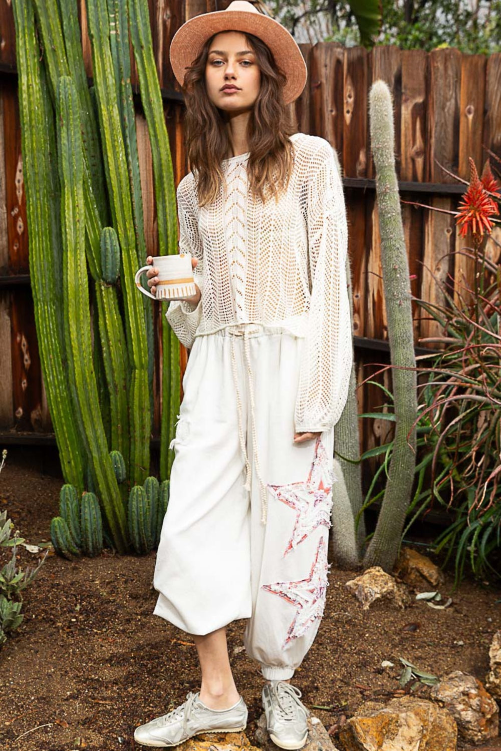 The Openwork Balloon Sleeve Knit Cover Up is a chic addition to any wardrobe. The intricate openwork detailing on the sleeves adds a touch of elegance and sophistication to this knit cover up. S - L
