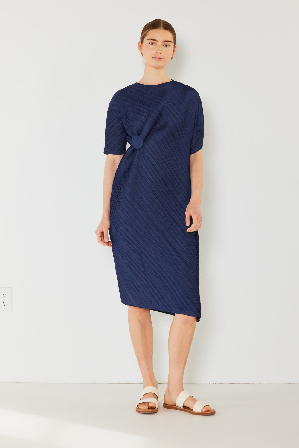 The Pleated Dolman Sleeve Dress is a modern and chic addition to your wardrobe. With its unique dolman sleeves and pleated detailing, this dress offers a stylish and sophisticated look. The relaxed silhouette and pleats create a flattering and comfortable fit.