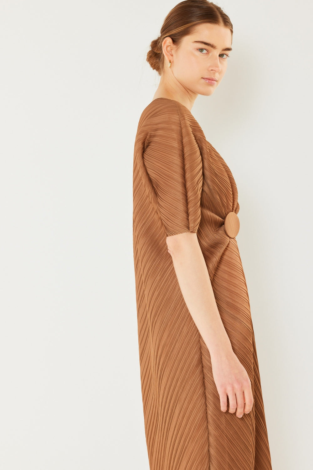 The Pleated Dolman Sleeve Dress is a modern and chic addition to your wardrobe. With its unique dolman sleeves and pleated detailing, this dress offers a stylish and sophisticated look. The relaxed silhouette and pleats create a flattering and comfortable fit.