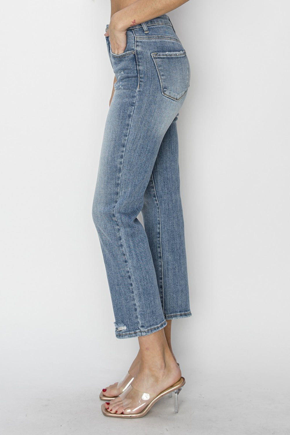 The High Waist Distressed Cropped Jeans are a trendy and edgy addition to your denim collection. The high waist design offers a flattering and on-trend silhouette. The distressed detailing adds a cool and rugged vibe to the cropped jeans.