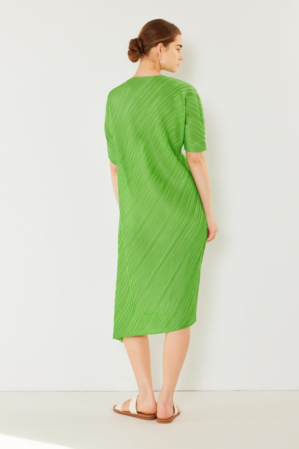The Pleated Dolman Sleeve Dress is a modern and chic addition to your wardrobe. With its unique dolman sleeves and pleated detailing, this dress offers a stylish and sophisticated look. The relaxed silhouette and pleats create a flattering and comfortable fit.