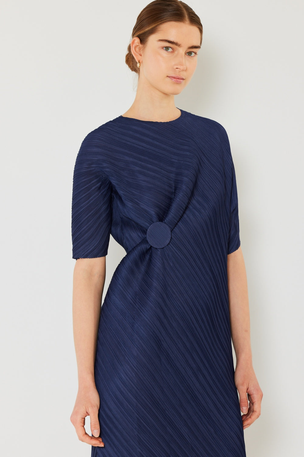 The Pleated Dolman Sleeve Dress is a modern and chic addition to your wardrobe. With its unique dolman sleeves and pleated detailing, this dress offers a stylish and sophisticated look. The relaxed silhouette and pleats create a flattering and comfortable fit.