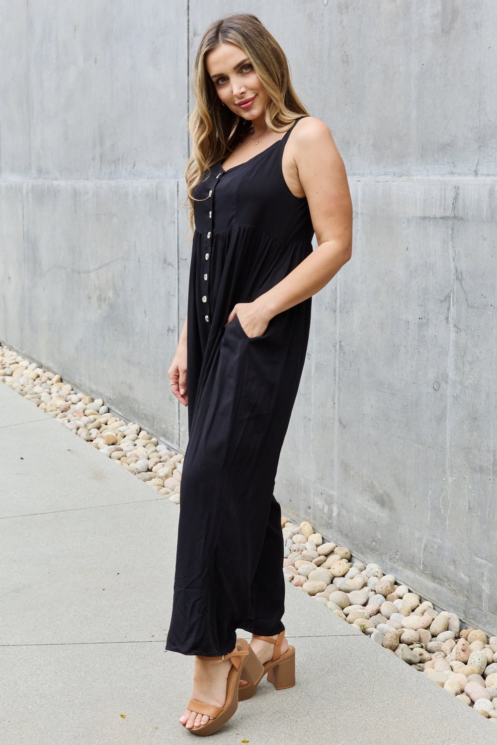 This jumpsuit is designed to be your go-to outfit for any occasion, whether you're running errands, attending a casual gathering, or simply lounging at home. This jumpsuit features a wide leg silhouette that not only offers a chic and contemporary look but also allows for unrestricted movement.