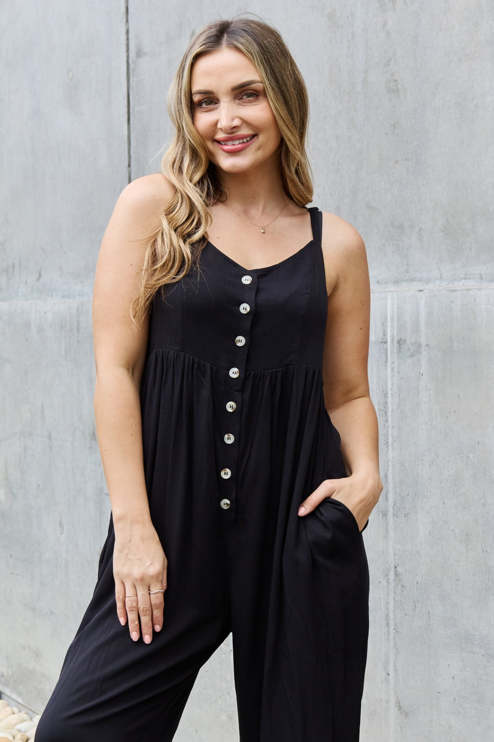 This jumpsuit is designed to be your go-to outfit for any occasion, whether you're running errands, attending a casual gathering, or simply lounging at home. This jumpsuit features a wide leg silhouette that not only offers a chic and contemporary look but also allows for unrestricted movement.