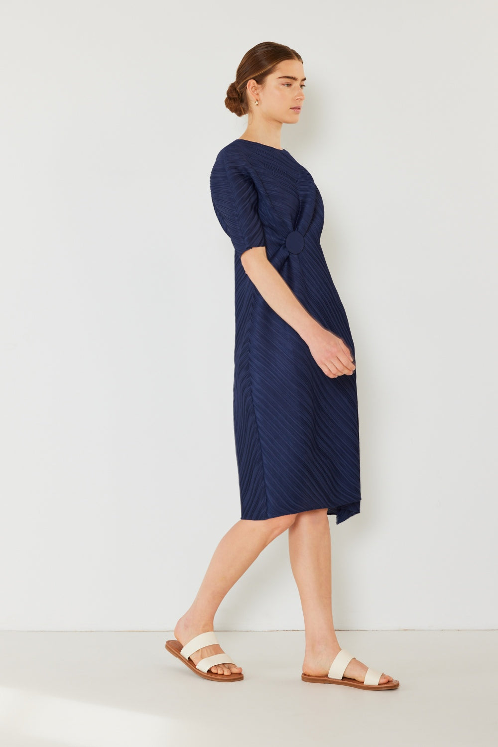 The Pleated Dolman Sleeve Dress is a modern and chic addition to your wardrobe. With its unique dolman sleeves and pleated detailing, this dress offers a stylish and sophisticated look. The relaxed silhouette and pleats create a flattering and comfortable fit.