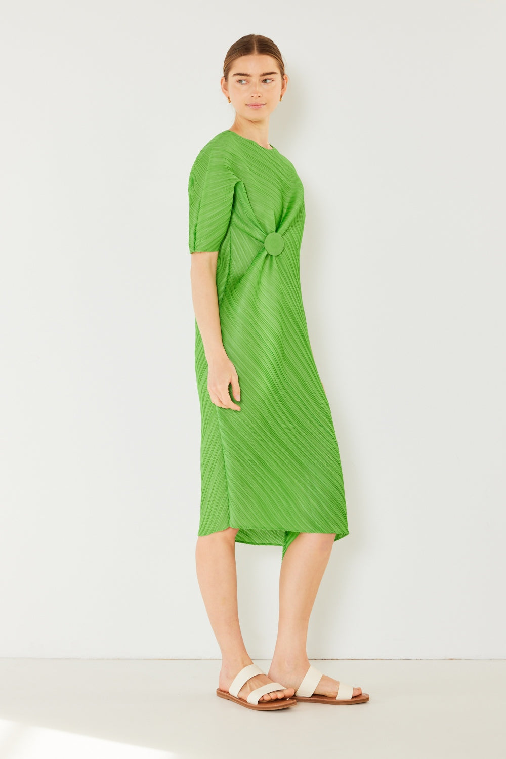 The Pleated Dolman Sleeve Dress is a modern and chic addition to your wardrobe. With its unique dolman sleeves and pleated detailing, this dress offers a stylish and sophisticated look. The relaxed silhouette and pleats create a flattering and comfortable fit.