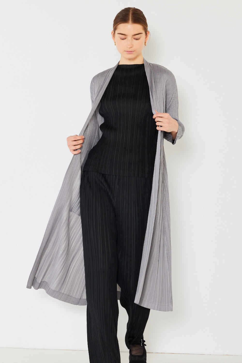 The Pleated Long Sleeve Cardigan is a versatile and chic layering piece for your wardrobe. With its pleated detailing and long sleeves, this cardigan offers a stylish and sophisticated look. The pleats add texture and visual interest to the classic cardigan design.