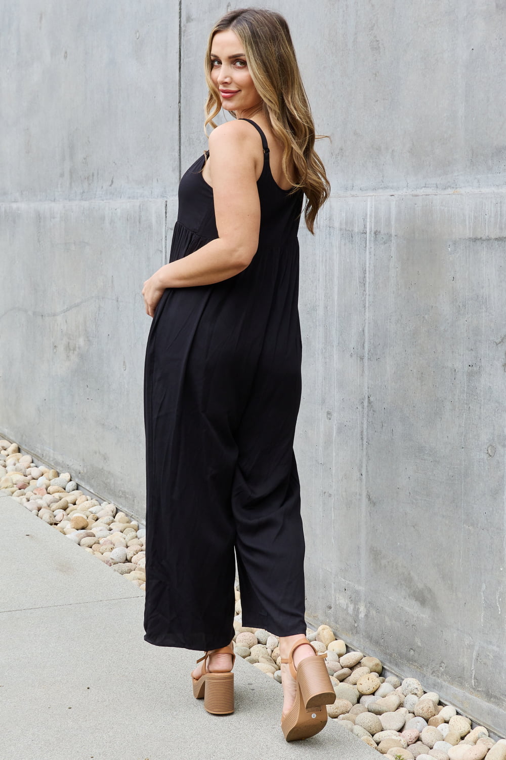 This jumpsuit is designed to be your go-to outfit for any occasion, whether you're running errands, attending a casual gathering, or simply lounging at home. This jumpsuit features a wide leg silhouette that not only offers a chic and contemporary look but also allows for unrestricted movement.