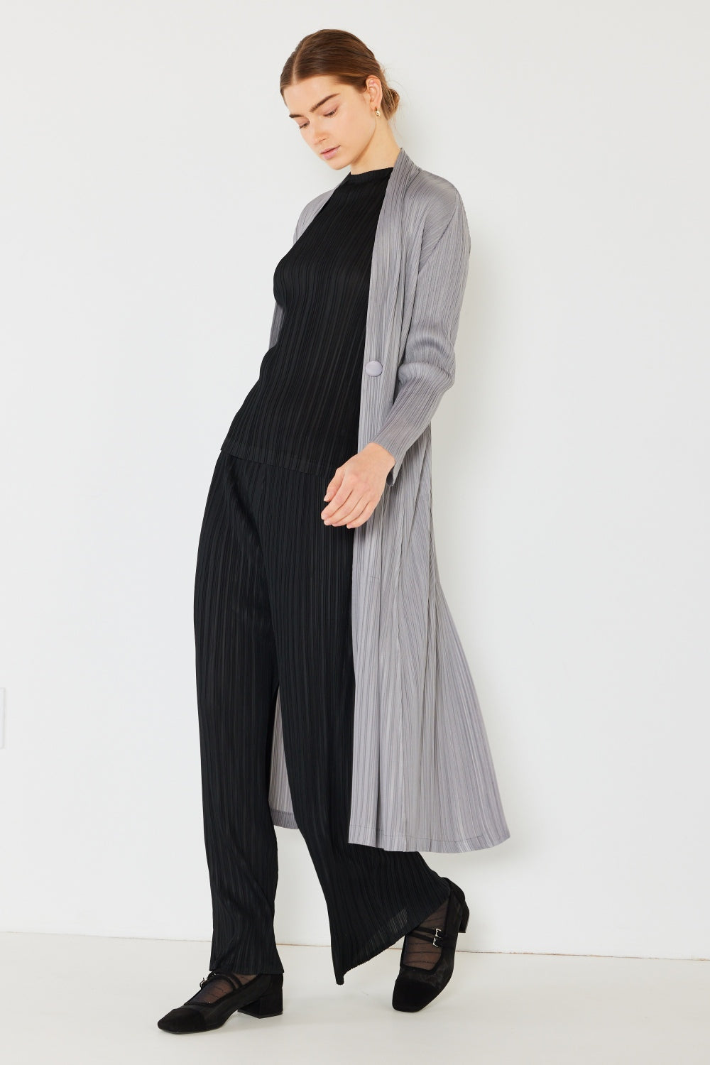 The Pleated Long Sleeve Cardigan is a versatile and chic layering piece for your wardrobe. With its pleated detailing and long sleeves, this cardigan offers a stylish and sophisticated look. The pleats add texture and visual interest to the classic cardigan design.